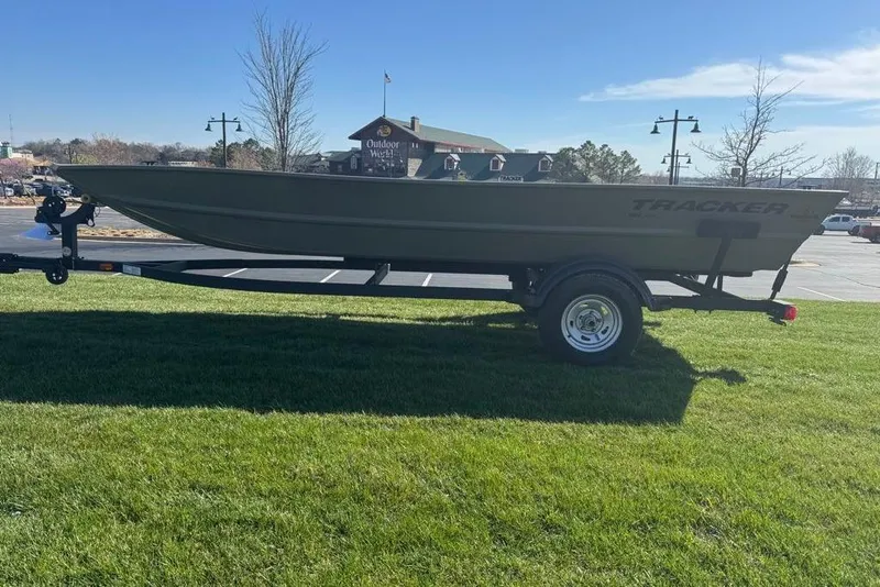 The Image of 2026 Tracker Grizzly 1754 Utility boat on trailer, parked on grass in sunny outdoor setting. - 0