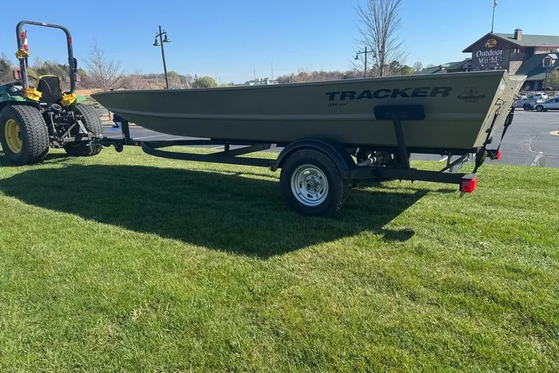 Slide: The Image of 2026 Tracker Grizzly 1754 Utility boat on trailer, parked on grass, sunny day. - 4