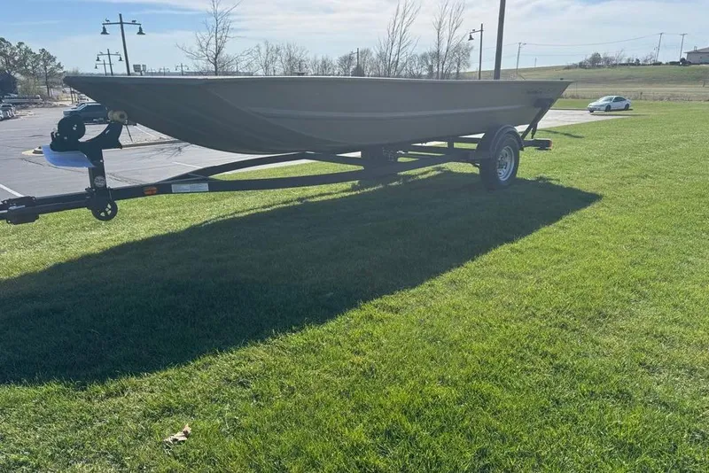 Slide: The Image of 2026 Tracker Grizzly 1754 Utility boat on trailer, parked on grassy area. - 5