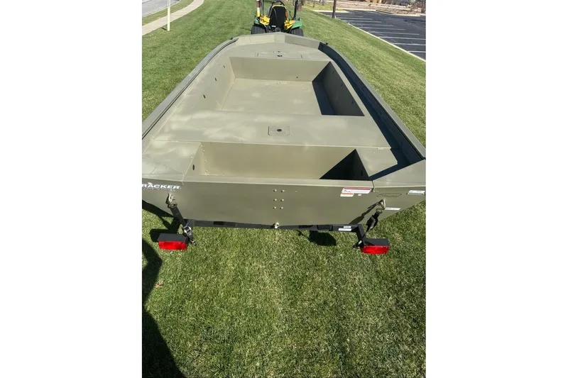 Slide: The Image of 2026 Tracker Grizzly 1754 Utility boat on grass, rear view. - 6