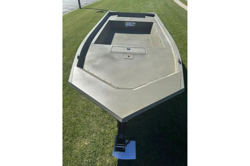 Slide: The Image of 2026 Tracker Grizzly 1754 Utility boat on grass, showcasing spacious interior and sturdy design. - 8