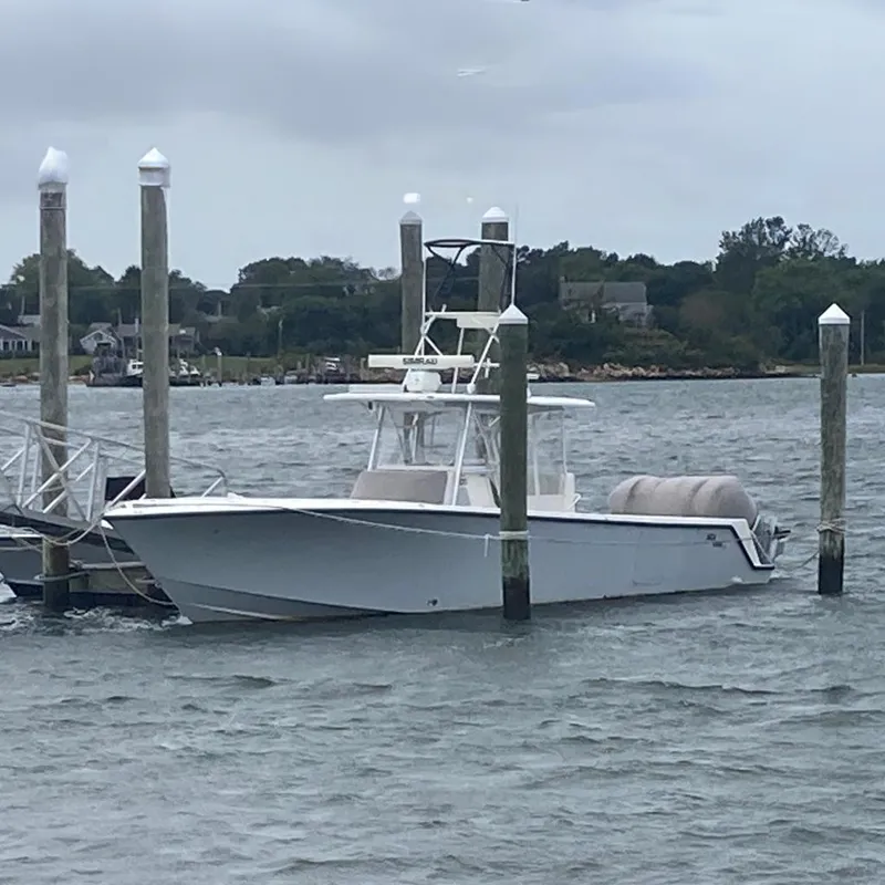 The Image of 2017 SeaVee 370z boat docked in a marina with calm waters. - 0