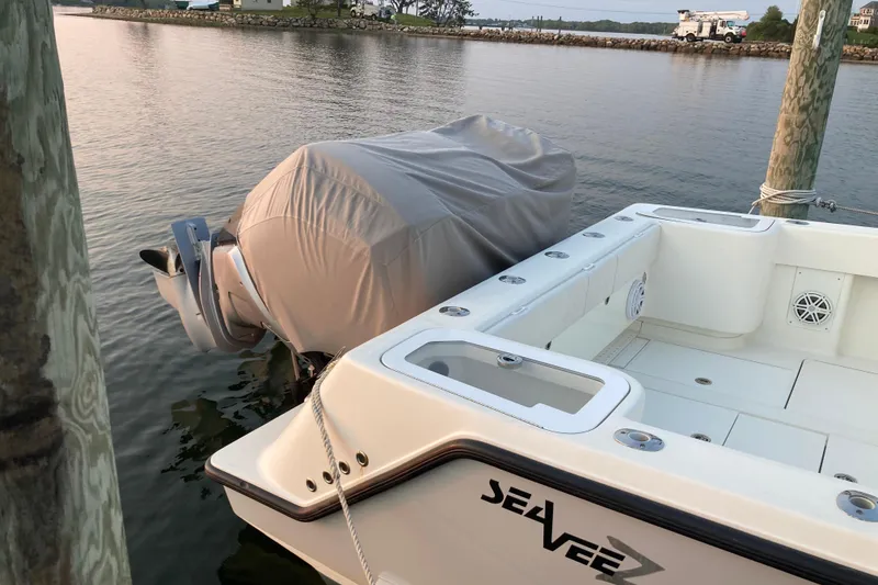 Slide: The Image of 2017 SeaVee 370z boat docked, covered engine, calm water, sunny day. - 14