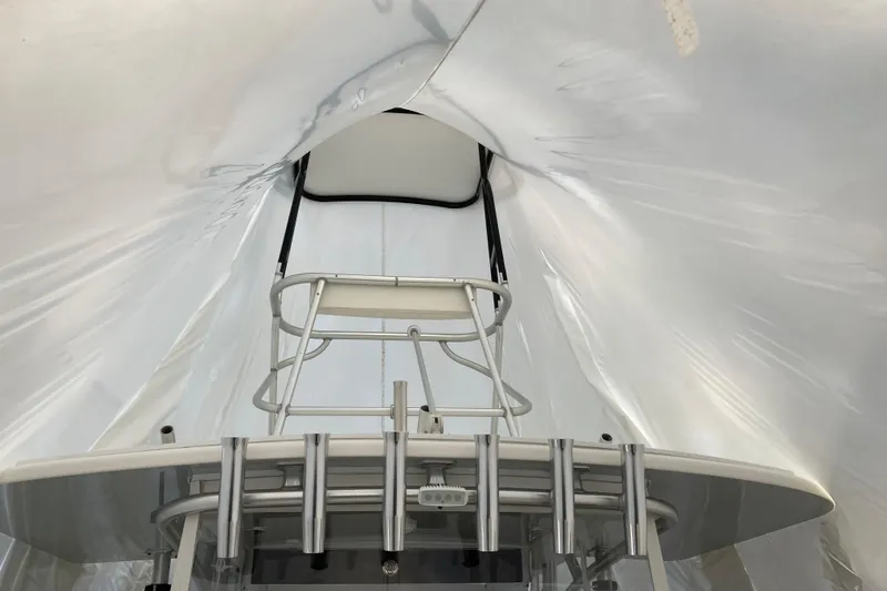 Slide: The Image of 2017 SeaVee 370z boat under protective cover, showcasing helm and seating area. - 17