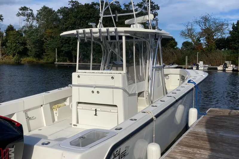 Slide: The Image of 2017 SeaVee 370z boat docked by a serene waterfront. - 7