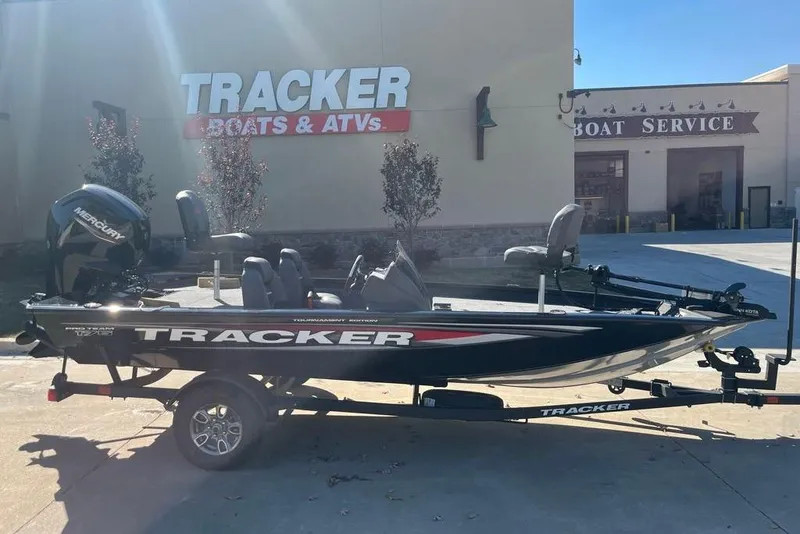 The Image of 2026 Tracker Pro Team 175 boat on trailer at dealership, featuring Mercury engine. - 0
