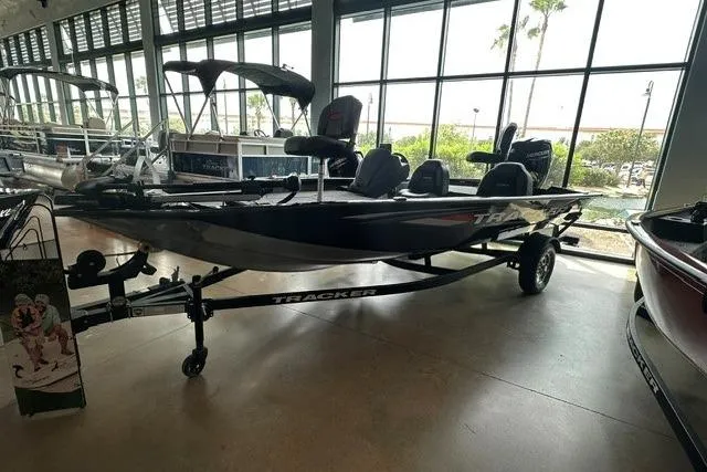 Slide: The Image of 2026 Tracker Pro Team 175 boat displayed indoors with trailer. - 2