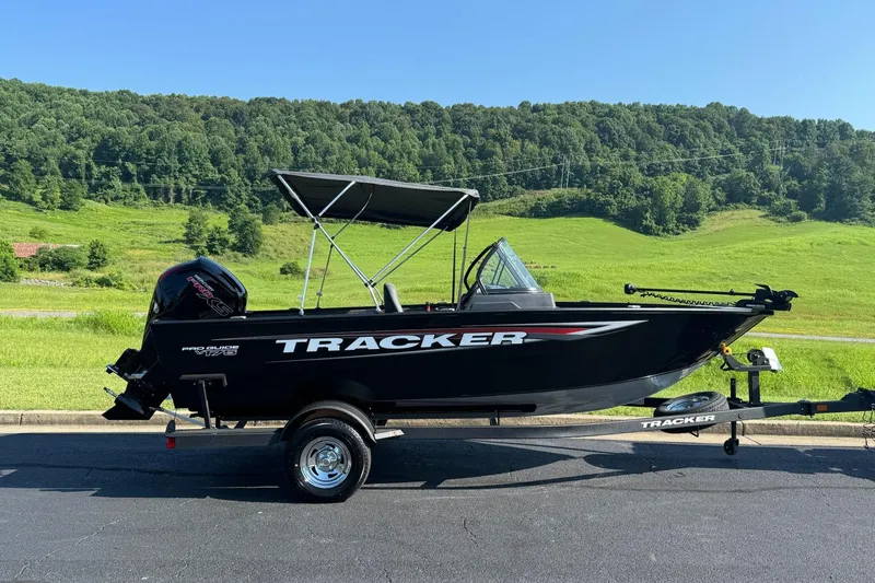 The Image of 2026 Tracker Pro Guide V-175 WT boat on trailer, scenic green landscape background. - 0