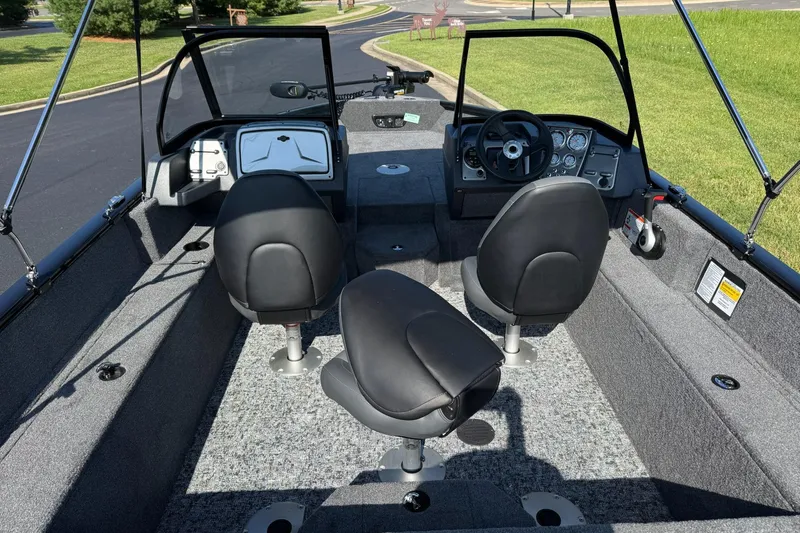 Slide: The Image of 2026 Tracker Pro Guide V-175 WT boat interior with steering console and seating. - 7