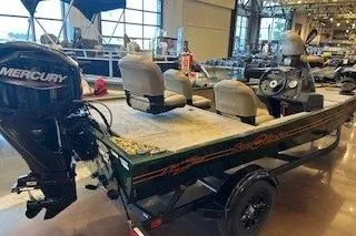 Slide: The Image of 2026 Tracker Bass Tracker Classic Limited boat displayed indoors with Mercury outboard motor. - 42