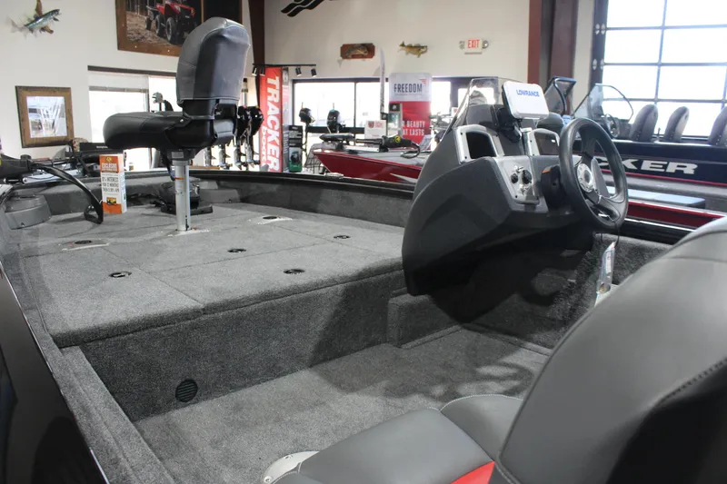 Slide: The Image of 2026 Tracker Pro Team 175 Crappie Edition boat interior with steering console and seating. - 7