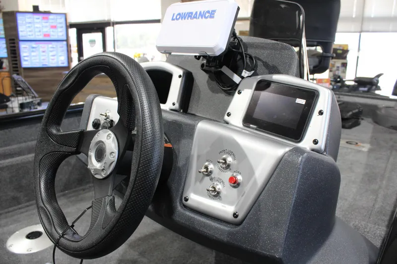 Slide: The Image of 2026 Tracker Pro Team 175 Crappie Edition boat dashboard with steering wheel and control panel. - 8