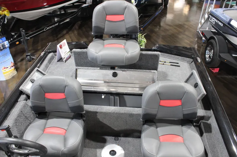 Slide: The Image of 2026 Tracker Pro Team 175 Crappie Edition boat interior with three gray and red seats. - 9