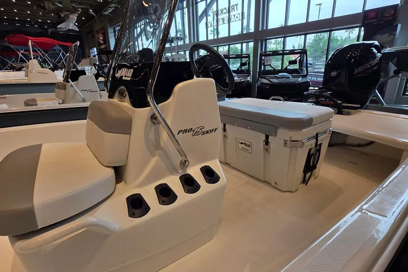 Slide: The Image of 2026 Mako Pro Skiff 15 CC boat interior with seating and storage. - 2