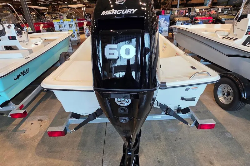 Slide: The Image of 2026 Mako Pro Skiff 15 CC with Mercury 60 engine displayed in showroom. - 3