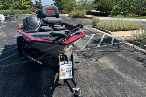 Slide: The Image of 2026 Tracker Pro Team 175 Crappie Edition boat parked in a lot, featuring sleek design and seating. - 2