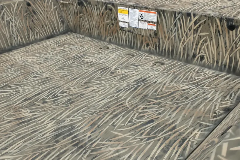 Slide: The Image of 2026 Tracker GRIZZLY 2072 Utility boat interior with camouflage pattern and safety labels. - 3