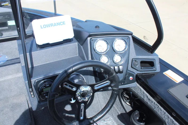 Slide: The Image of 2026 Tracker Targa V-18 Combo boat dashboard with Lowrance display and gauges. - 11