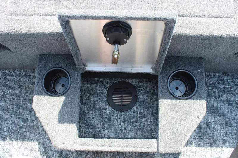 Slide: The Image of 2026 Tracker Targa V-18 Combo boat interior with cup holders and storage compartment. - 18