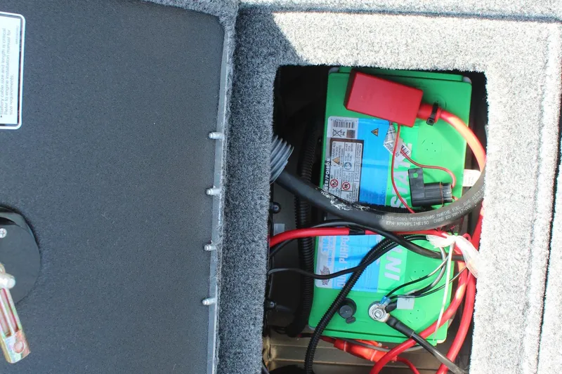 Slide: The Image of Battery compartment of 2026 Tracker Targa V-18 Combo boat, showing wiring and connections. - 21