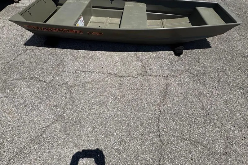 The Image of 2026 Tracker Grizzly 12 Jon boat on pavement, showcasing its sturdy design and compact size. - 0