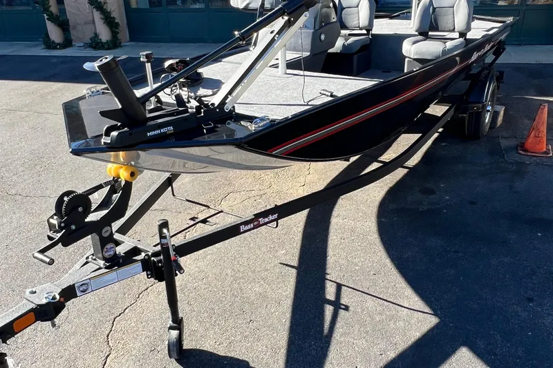 Slide: The Image of 2026 Tracker Bass Tracker Classic XL boat on trailer, parked outdoors. - 2