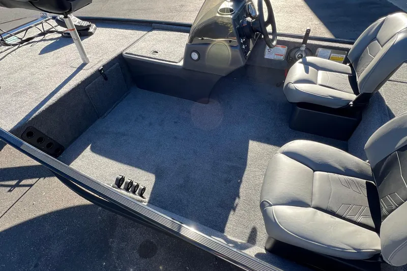 Slide: The Image of 2026 Tracker Bass Tracker Classic XL boat interior with seating and steering console. - 3