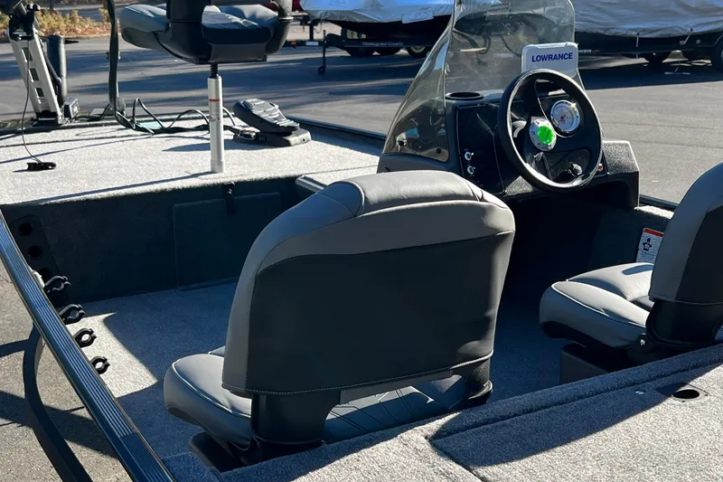 Slide: The Image of 2026 Tracker Bass Tracker Classic XL boat interior with steering console and seating. - 4