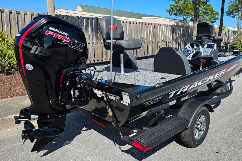 Slide: The Image of 2026 Tracker Pro Team 190 boat with Mercury Pro XS 115 engine, parked outdoors. - 2