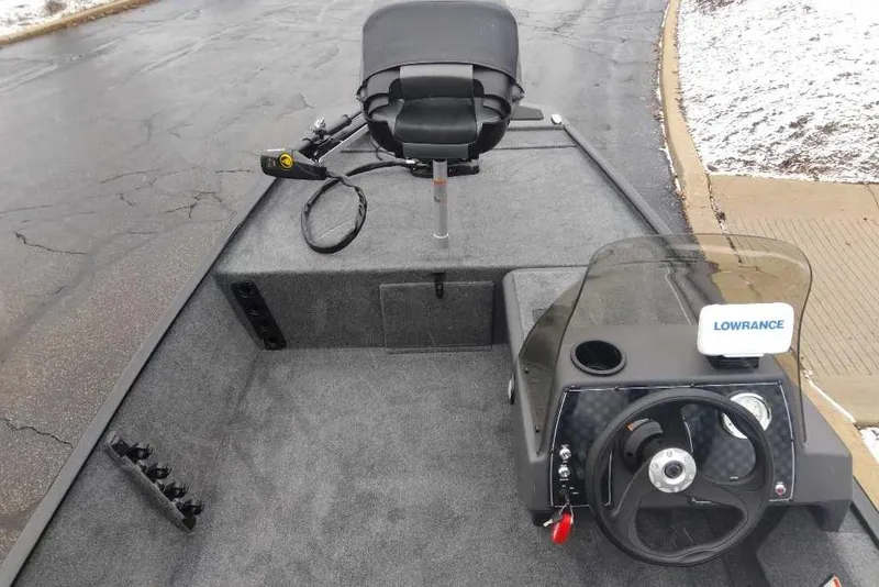 Slide: The Image of 2026 Tracker Bass Tracker Classic XL boat interior with steering wheel and Lowrance fish finder. - 3