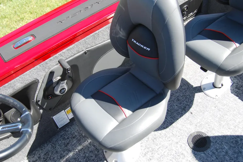 Slide: The Image of 2026 Tracker Targa V-18 WT boat interior with gray seats and steering controls. - 10