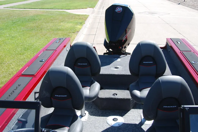 Slide: The Image of 2026 Tracker Targa V-18 WT boat interior with four seats and outboard motor. - 3