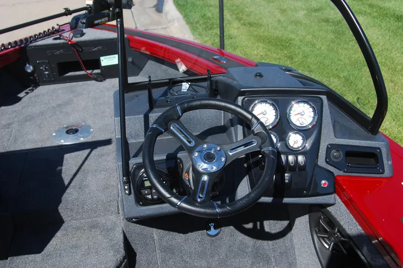 Slide: The Image of 2026 Tracker Targa V-18 WT boat dashboard with steering wheel and gauges. - 4