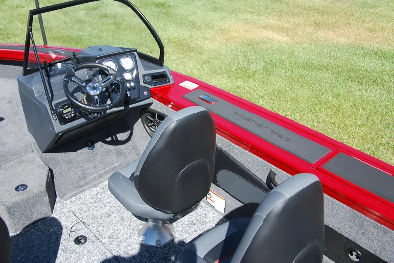 Slide: The Image of 2026 Tracker Targa V-18 WT boat interior with steering console and seating. - 9