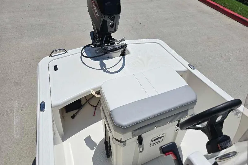 Slide: The Image of 2026 Mako Pro Skiff 15 CC boat interior with motor and seating. - 59