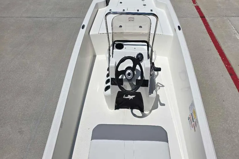Slide: The Image of 2026 Mako Pro Skiff 15 CC boat interior with steering console and seating. - 62