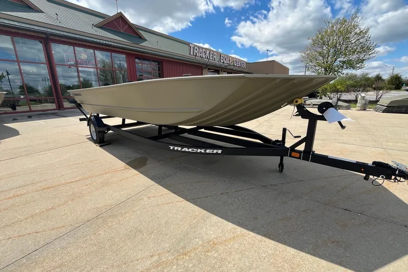 Slide: The Image of 2026 Tracker Grizzly 2072 Utility boat on trailer at dealership under blue sky. - 10