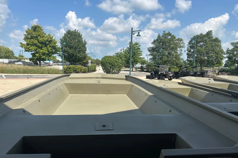Slide: The Image of 2026 Tracker GRIZZLY 2072 Utility boat on display, surrounded by trees and clear sky. - 2