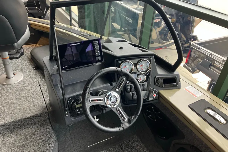 Slide: The Image of Interior view of 2026 Tracker Targa V-18 Combo boat dashboard with steering wheel and gauges. - 4