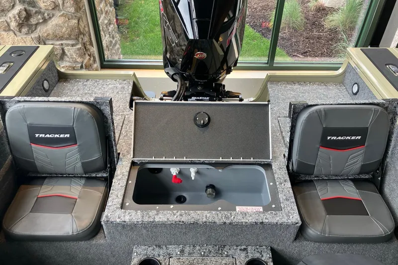 Slide: The Image of 2026 Tracker Targa V-18 Combo boat interior with seating and motor view. - 6