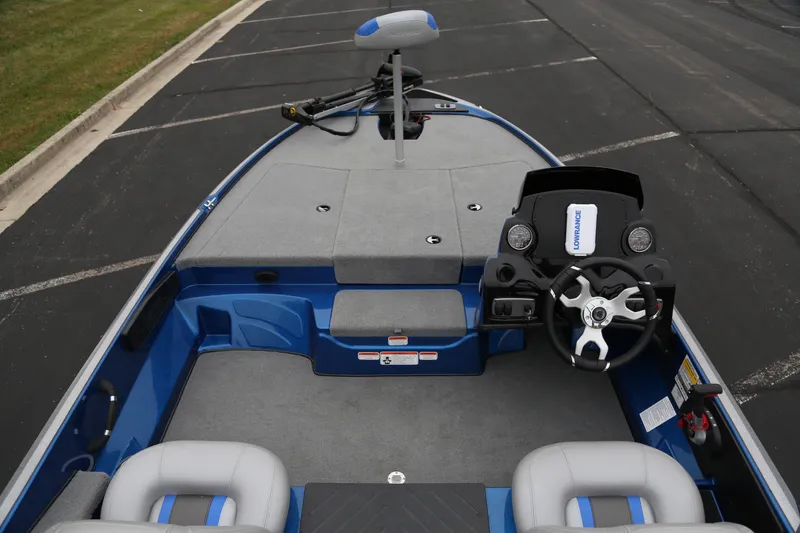 Slide: The Image of 2026 Nitro Z17 boat interior with steering wheel and seating, parked on asphalt. - 5