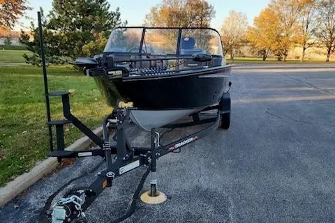 The Image of 2026 Tracker Targa V-18 Combo boat on trailer in a scenic park setting. - 0