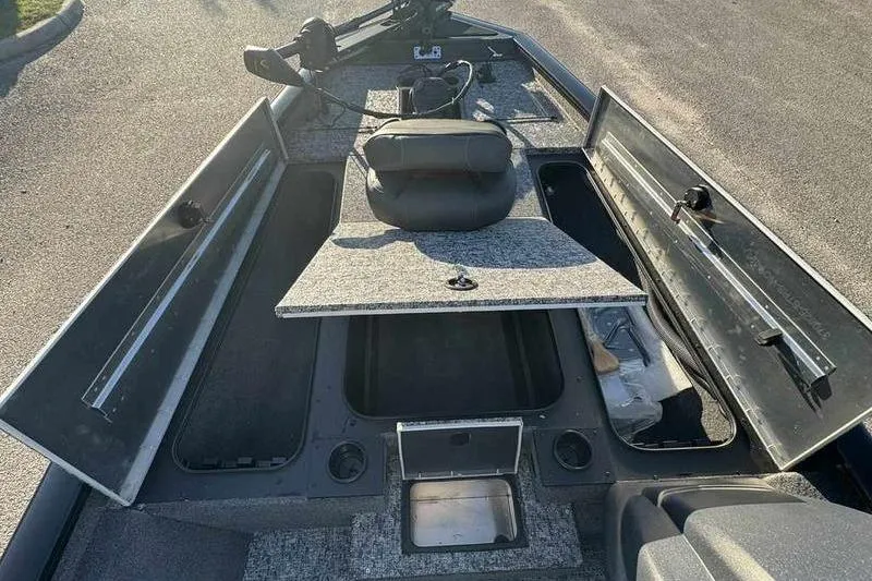 Slide: The Image of 2026 Tracker Pro Team 190 boat interior with open storage compartments and seating. - 12