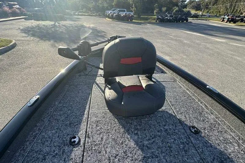 Slide: The Image of 2026 Tracker Pro Team 190 boat with a single seat on deck, parked outdoors. - 13