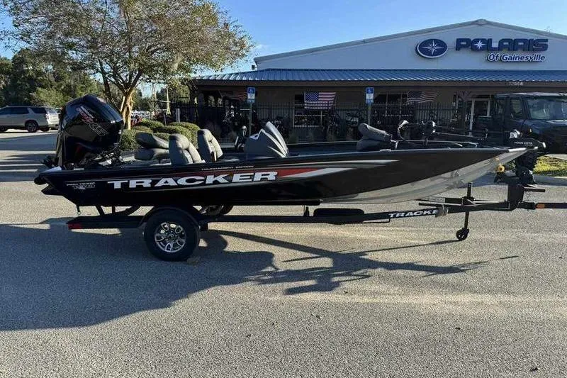 Slide: The Image of 2026 Tracker Pro Team 190 boat on trailer outside dealership. - 7