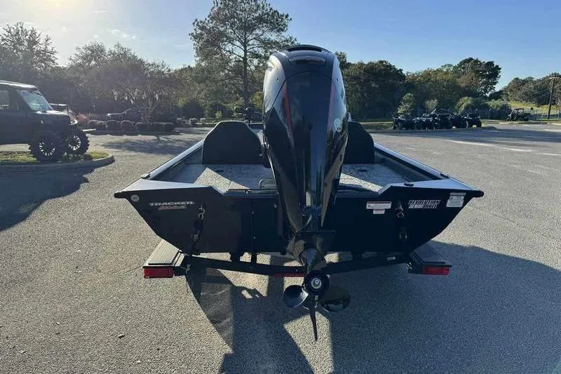 Slide: The Image of 2026 Tracker Pro Team 190 boat with outboard motor in a sunny parking lot. - 9