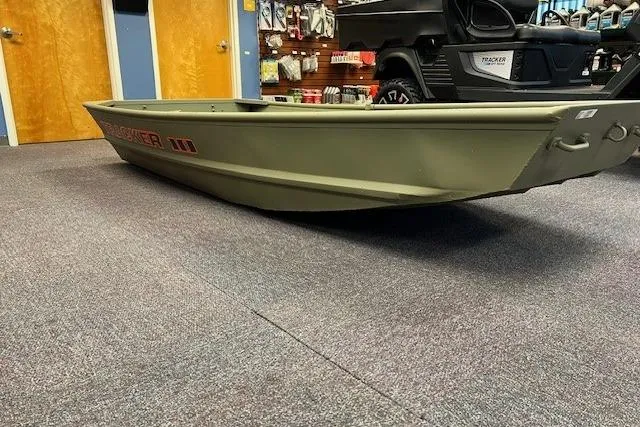 Slide: The Image of 2026 Tracker Grizzly 10 Jon boat displayed indoors on carpeted floor. - 3