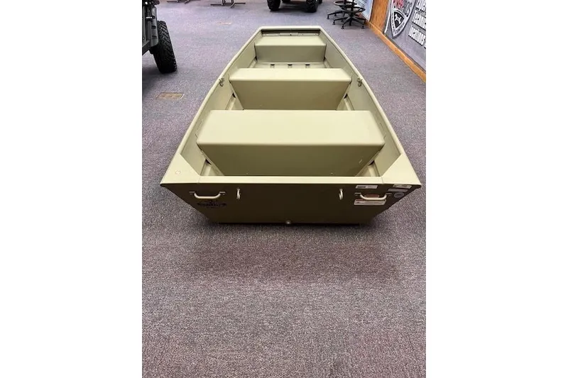 Slide: The Image of 2026 Tracker Grizzly 10 Jon boat displayed indoors on carpeted floor. - 4