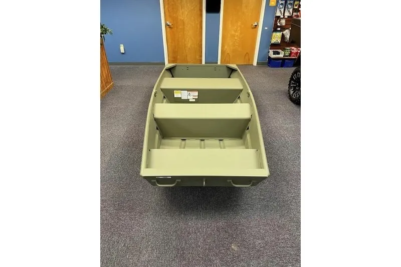 Slide: The Image of 2026 Tracker Grizzly 10 Jon boat displayed indoors on carpeted floor. - 5