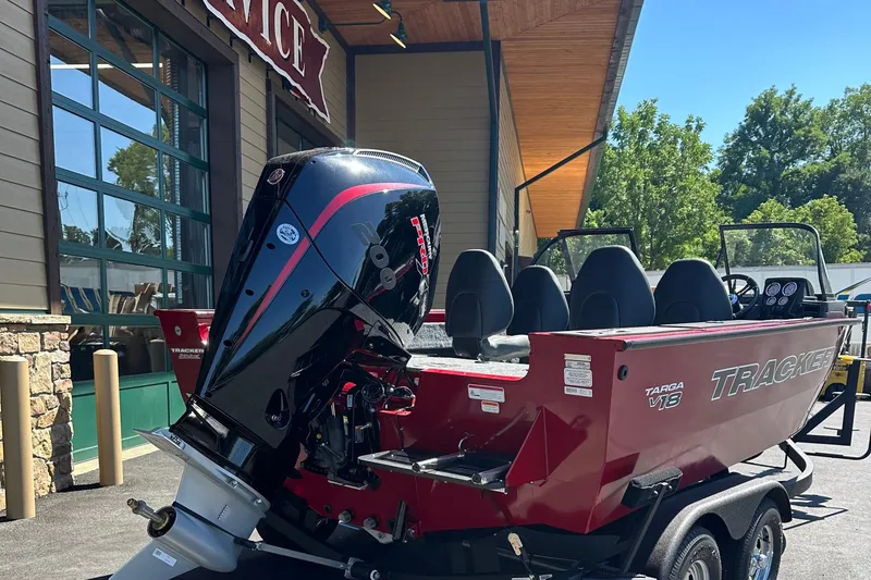 Slide: The Image of 2026 Tracker Targa V-18 Combo boat with powerful outboard motor, parked outdoors. - 3